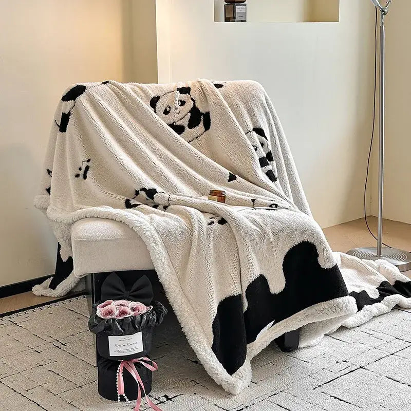 Cream-colored jacquard lamb wool blanket with black panda and paw prints soft fleece texture living room throw