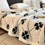 Cream-colored plush jacquard lamb wool blanket with black floral embroidery for living room throw use