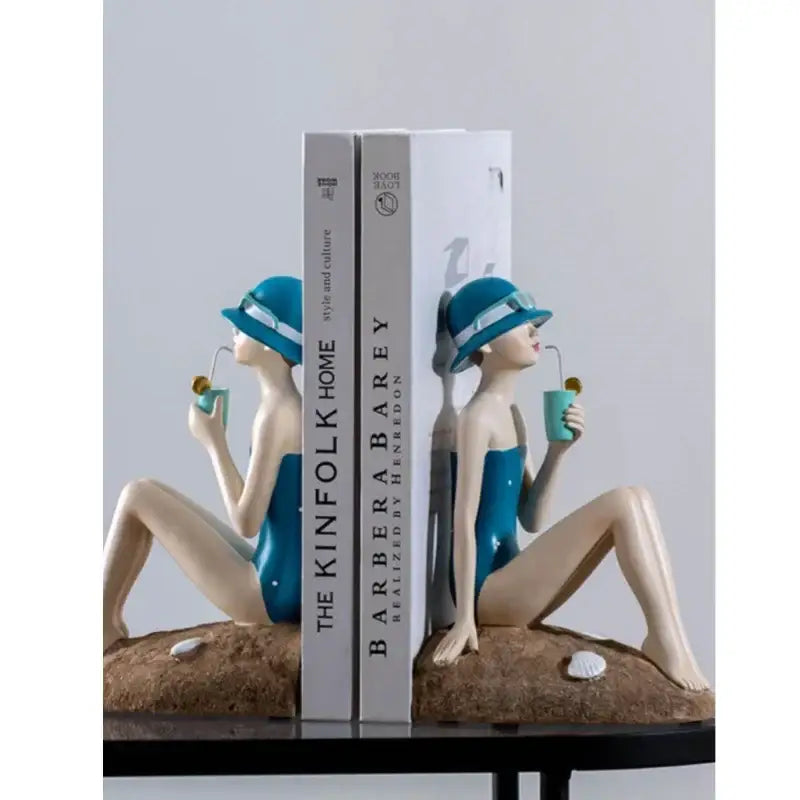 Blue resin figure sculpture bookends shaped like vintage beachside women with drinks for living room decor