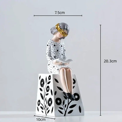 Delicate porcelain resin figure sculpture of a gray haired woman with gold leaf and polka dot dress on floral pedestal
