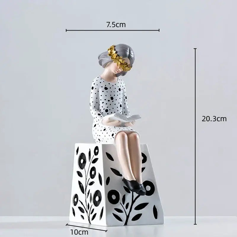 Delicate porcelain resin figure sculpture of a gray haired woman with gold leaf and polka dot dress on floral pedestal