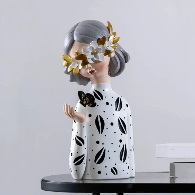 A white resin figure sculpture of a woman with gray hair wearing a floral crown for living room decor