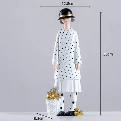 A stylish white resin figure sculpture of a woman in a polka dot coat holding a basket with golden flowers