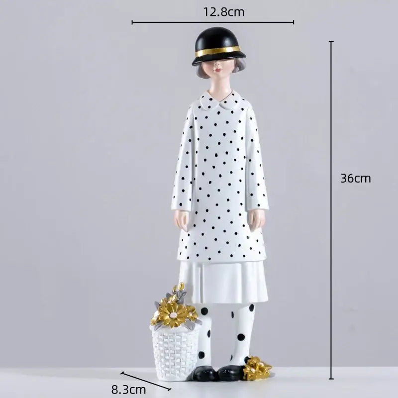 A stylish white resin figure sculpture of a woman in a polka dot coat holding a basket with golden flowers