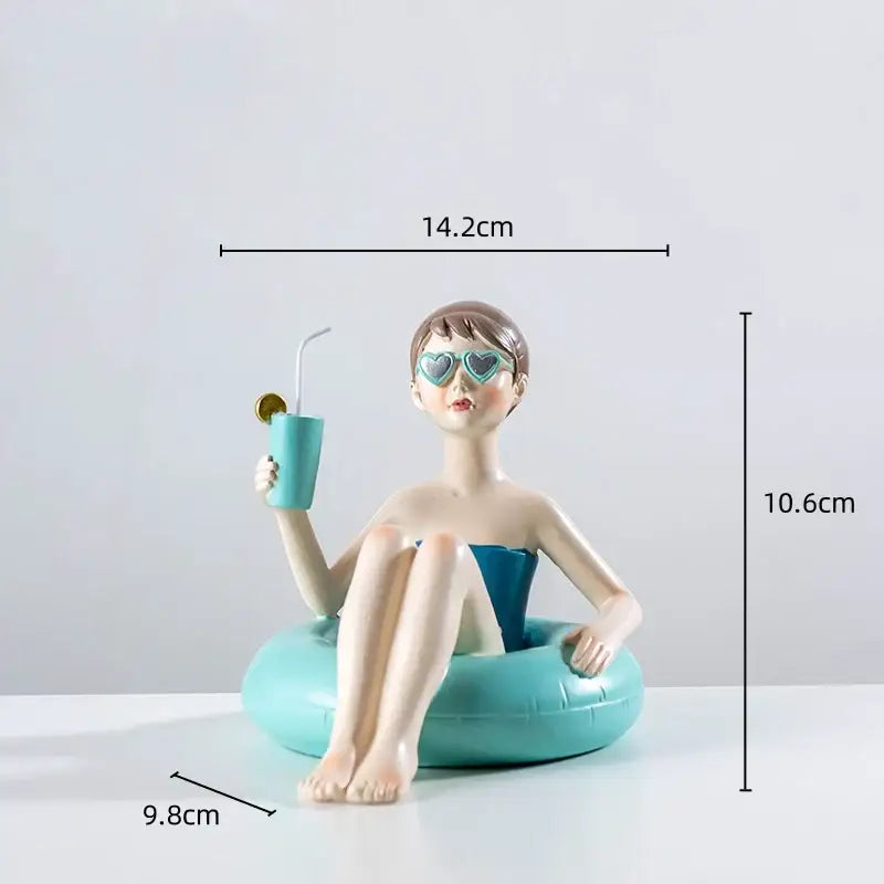 Turquoise resin figure sculpture of a woman in blue swimsuit sitting on an inflatable ring holding a matching drink