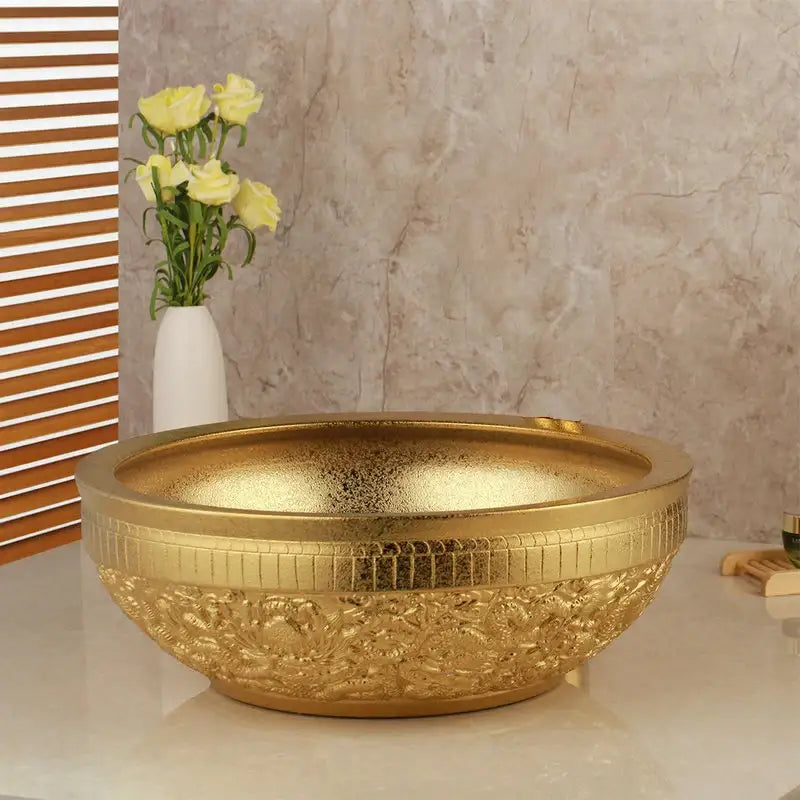 Floral embossed golden ceramic washbasin with intricate detailing paired with a brass mixer faucet bathroom set decorbites golden ceramic
