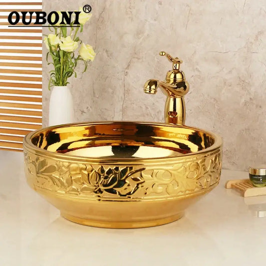 Decorbites golden ceramic washbasin with intricate floral embossing and matching brass mixer faucet bathroom set