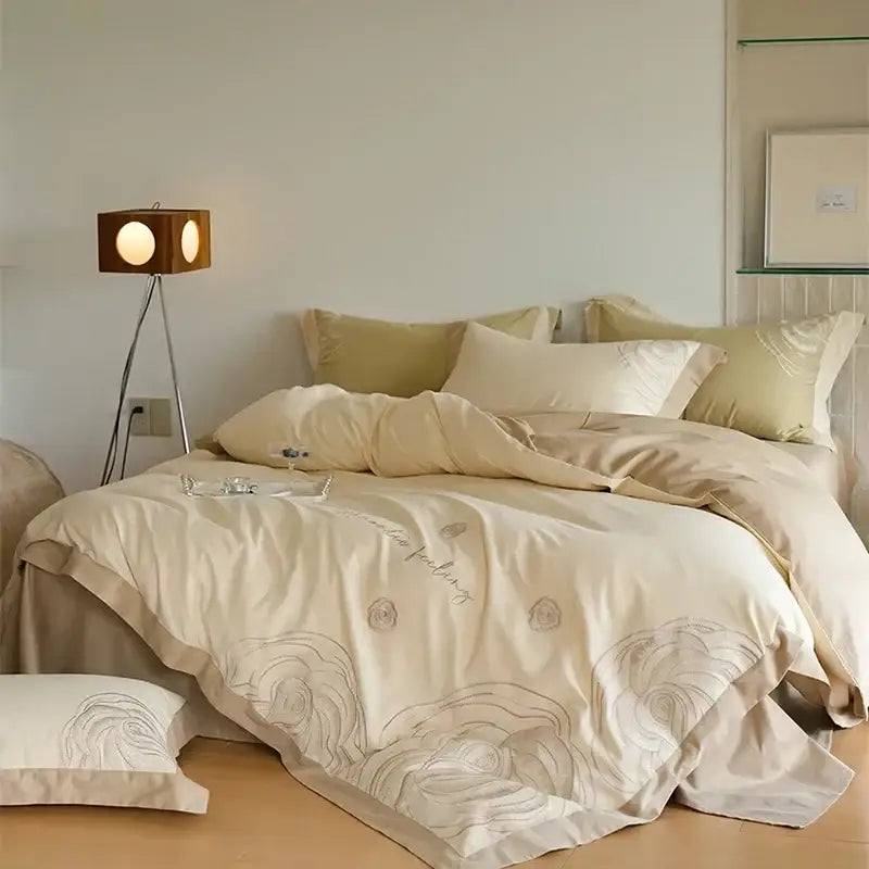 Cream-colored satin duvet cover set with delicate gray floral embroidery for elegant bedroom decor