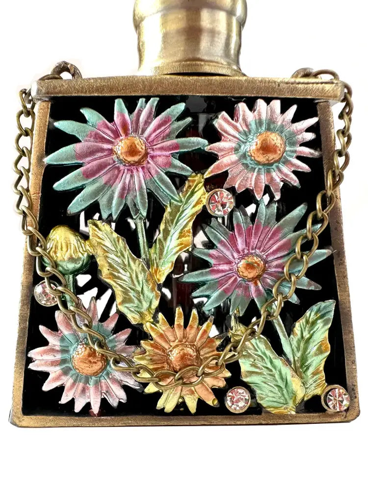 A square enamel perfume bottle with gold metal handicraft cap and pink teal floral design for bedroom decor