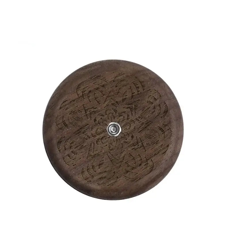 Dark brown wooden circular french bread lame with intricate floral engraving and central metallic screw for bread lame dough scoring decorbites french bread
