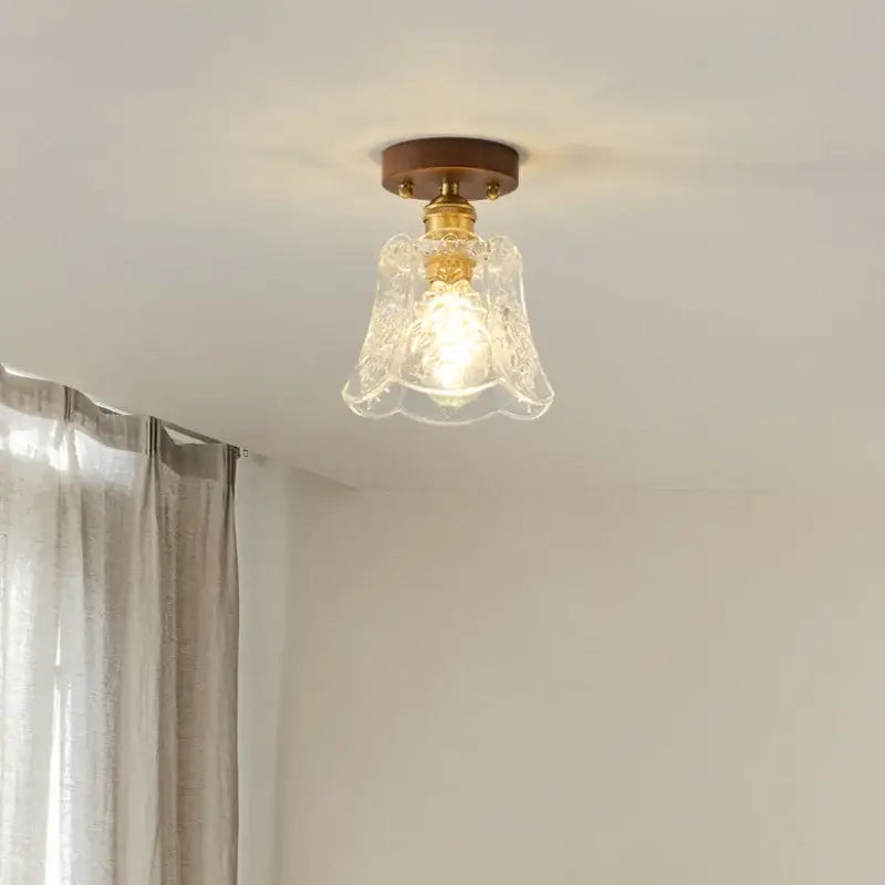 Floral etched glass led ceiling lamp with brass finish and walnut wood mounting plate for living room use
