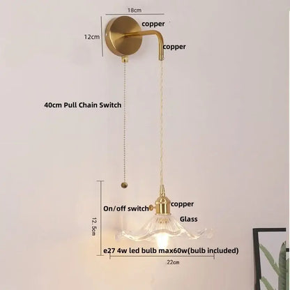 A brass-finished floral glass copper led wall sconce with curved arm and clear shade includes 4w led bulb for bathroom use
