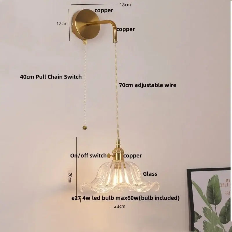 Floral glass copper led wall sconce with a delicate translucent fluted glass shade hanging from adjustable copper led wall fixture