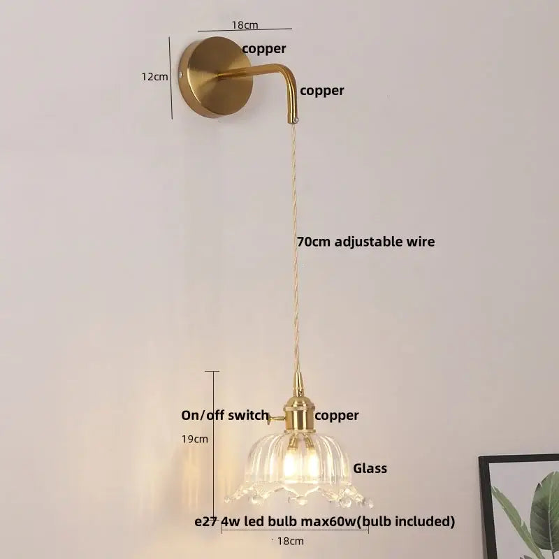 A floral glass copper led wall sconce with a brass finish curved arm and adjustable 70cm wire for bathroom lighting