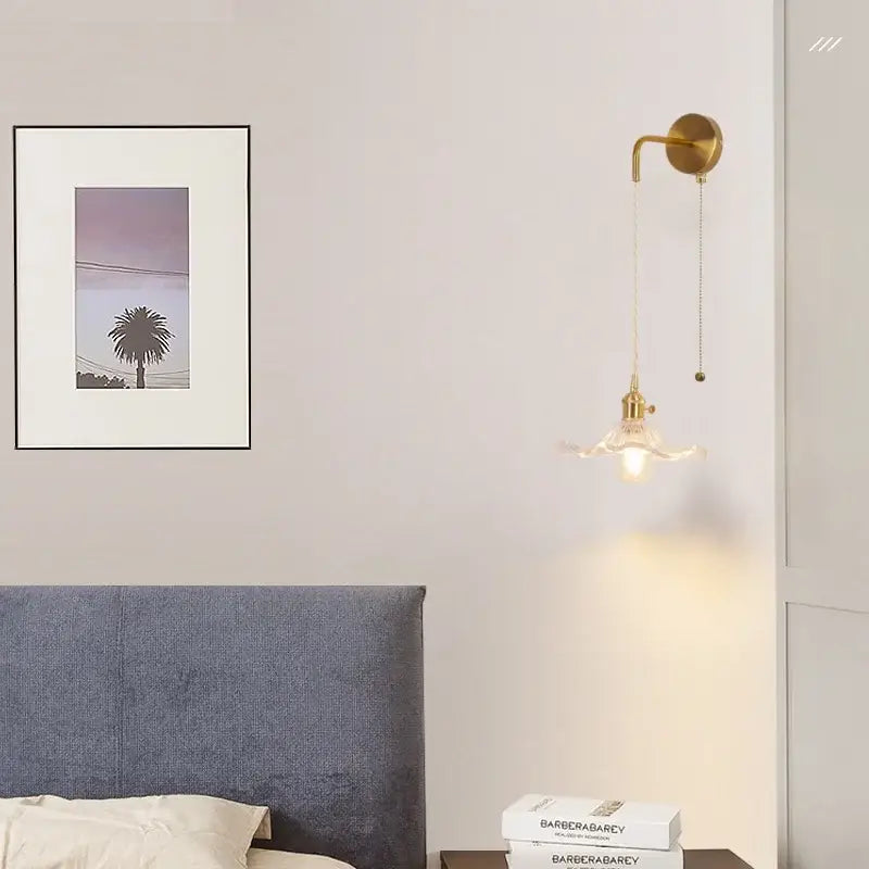 Gold-toned floral glass copper led wall sconce with fluted shade and elegant curved arm for bathroom lighting