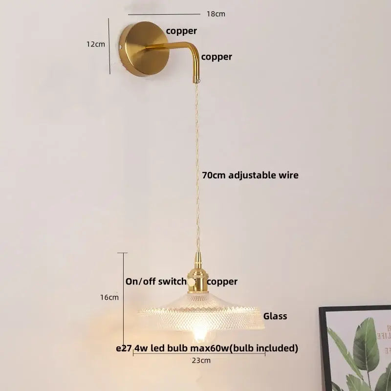 Gold-toned copper led wall sconce with textured glass shade and adjustable wire for bathroom lighting