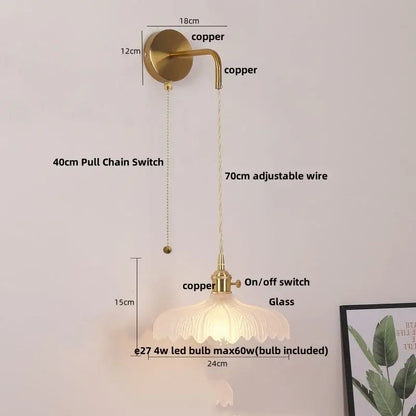 Vintage-style wall sconce with glass copper led fluted shade in brass finish for elegant bathroom lighting