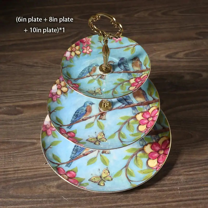 Three-tiered fruit plates set with light blue bone china tiers decorated with birds and gold-toned handles