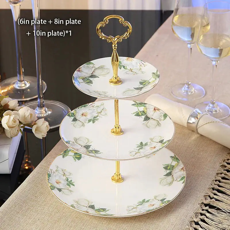 Three-tiered fruit plates set with gold bone china stand featuring white ceramic floral plates in soft green and cream hues