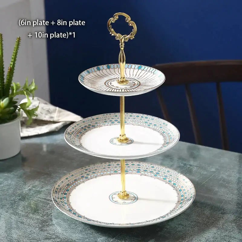 Three-tiered bone china fruit plates set with gold-toned handle featuring blue and black geometric rim patterns