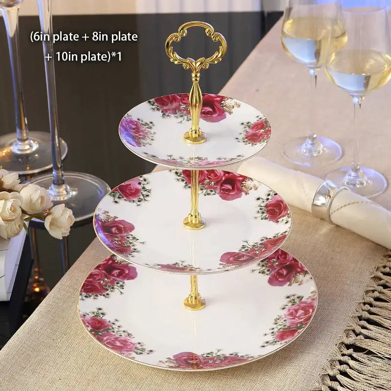 Three-tiered fruit plates set with gold-toned ornate handle and white bone china plates featuring pink rose floral pattern