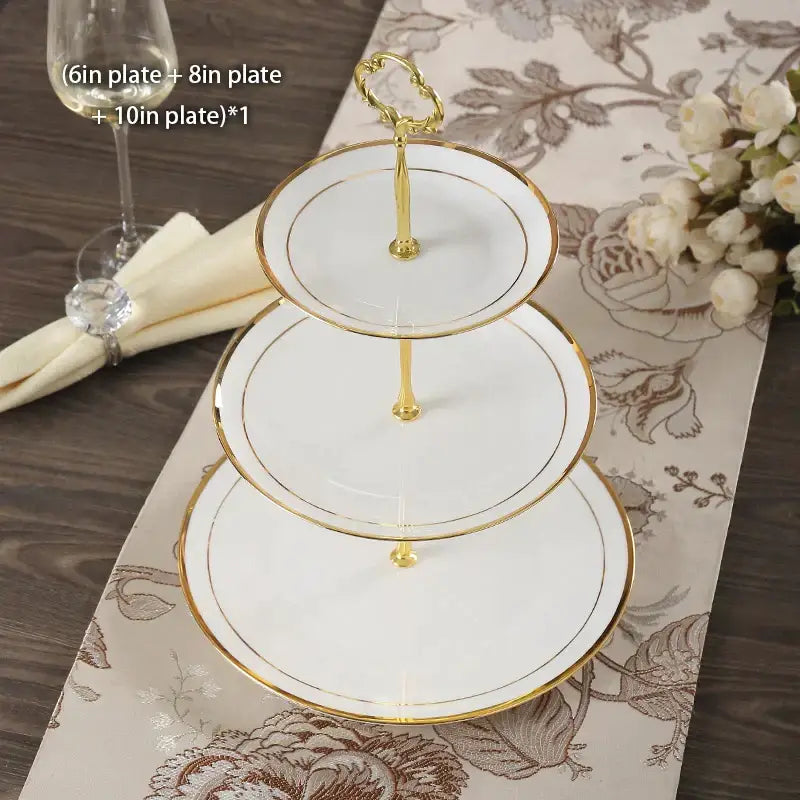 Elegant three-tiered fruit plates set with white bone china and gold-trimmed edges on a decorative gold stand