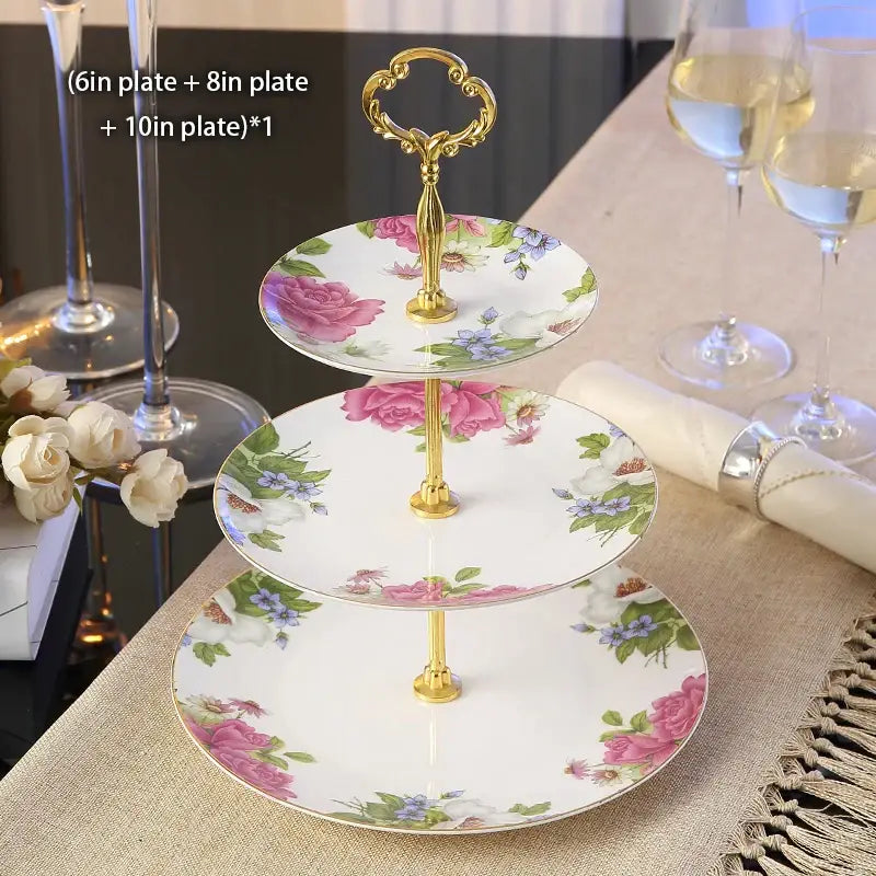 Three-tiered fruit plates set with gold-toned handle featuring white bone china plates decorated with floral patterns