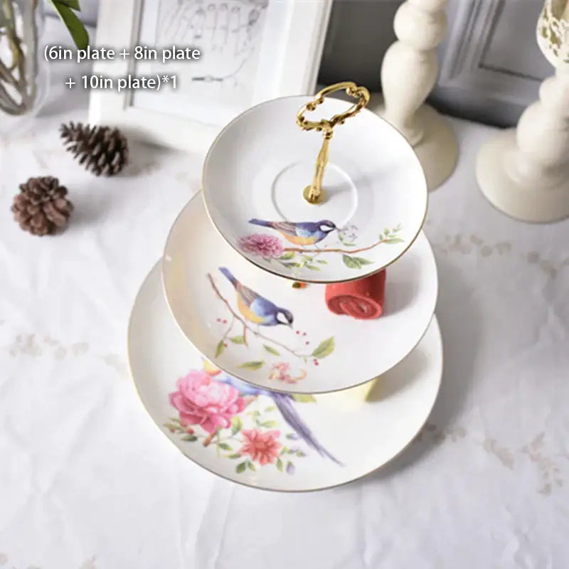 Three-tiered bone china fruit plates set with gold handle featuring hand-painted blue and yellow birds and pink roses