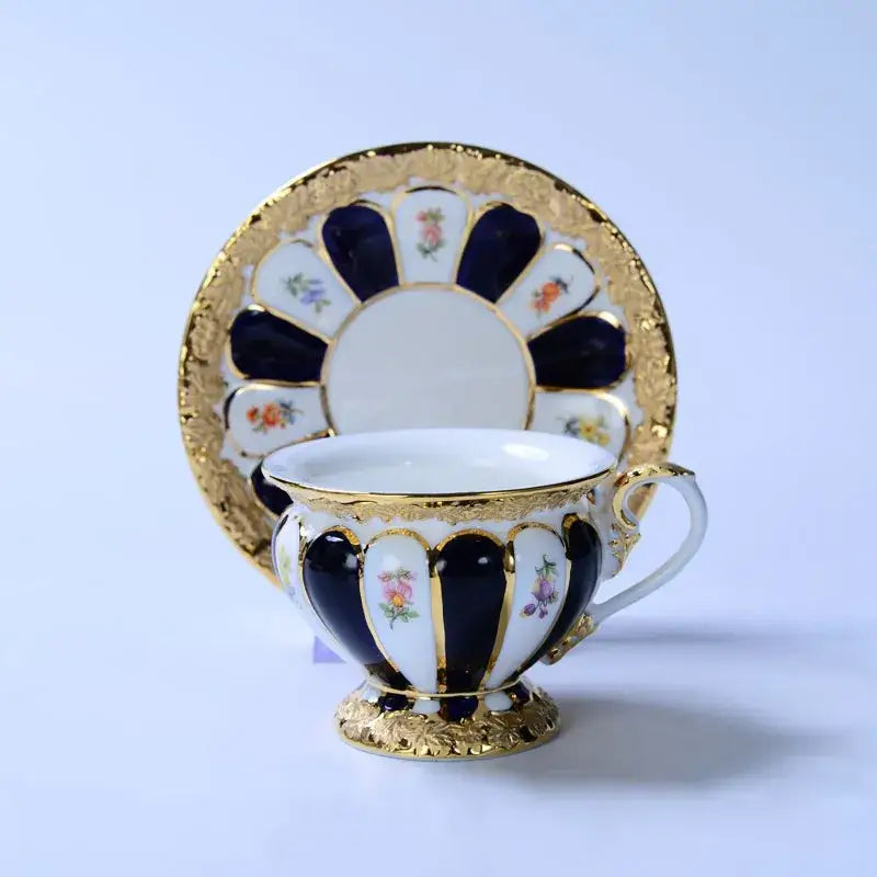 Elegant porcelain tea cup saucer set with navy blue white and gold floral hand-painted accents for dining room use