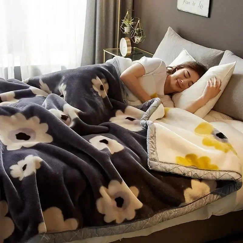 A plush dark gray cozy flocked raschel blanket with soft white and yellow floral patterns and quilted border for bedding decorbites cozy flocked