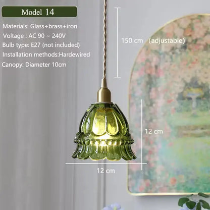 Green glass pendant light with brass and iron fixture featuring a floral green glass shade for kitchen use