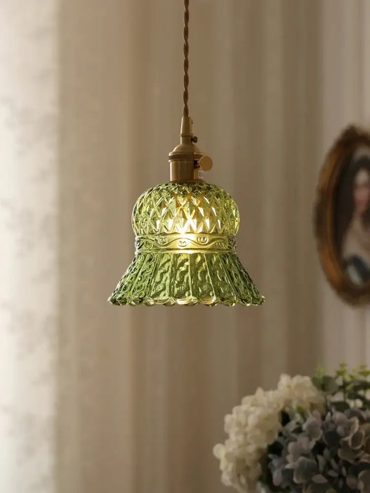 Floral green glass pendant light with diamond-cut leaf-patterned green glass shade and brass-finished hardware
