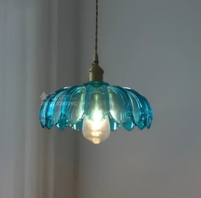 Floral green glass pendant light with delicate petal design and golden brass finish ideal for dining room pendant lights