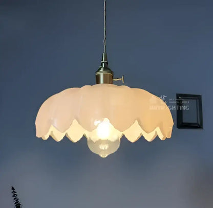 Vintage-style glass pendant light with soft peach scalloped shade and brass finish ideal for dining room lighting