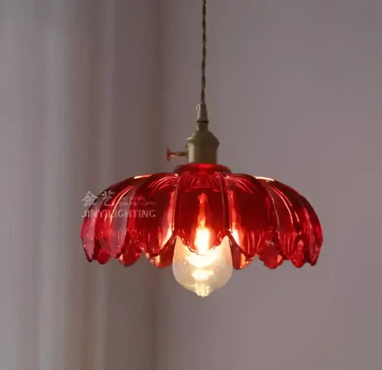 A vibrant red petal-shaped glass pendant light with vintage brass fixture for dining room golden brass finish pendant lights