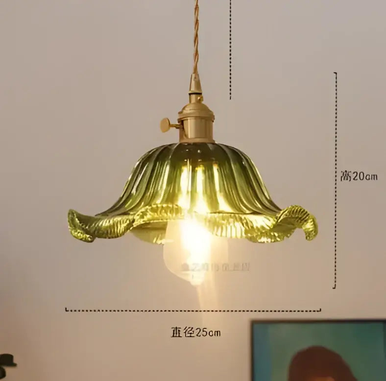 Floral green glass pendant light with golden brass finish featuring a golden petal-shaped glass pendant light with warm glow
