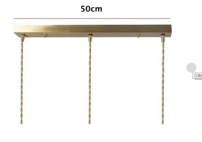 A sleek 50cm brass pendant light with three twisted copper chains for dining room glass pendant lighting