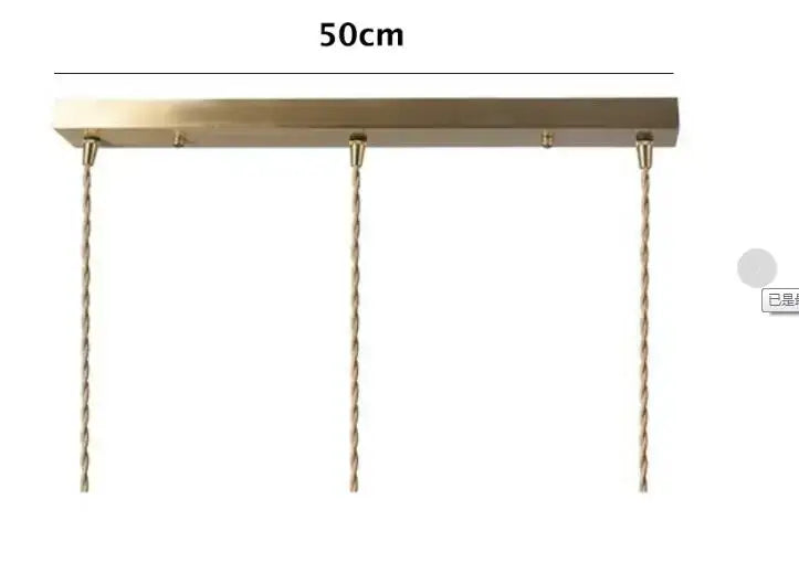 A sleek 50cm brass pendant light with three twisted copper chains for dining room glass pendant lighting