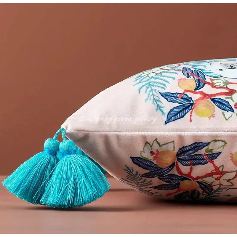 Cream-colored decorbites handmade lumbar pillow case with embroidered botanical patterns and turquoise tassels for bedroom decor