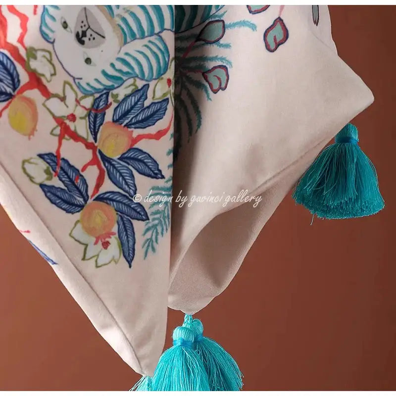 Cream-colored fabric decorbites handmade lumbar pillow case with embroidered blue foliage and whimsical white tiger design