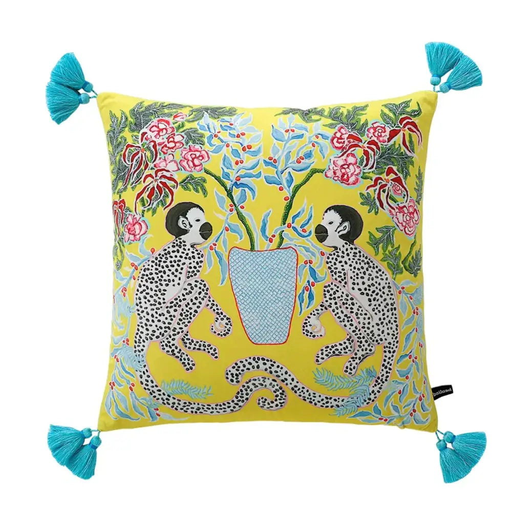 Vibrant yellow decorbites handmade lumbar pillow case with embroidered spotted monkeys floral pattern and turquoise tassels