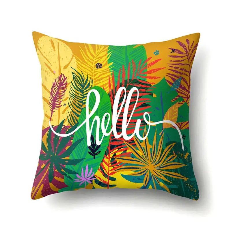 Vibrant green tropical leaves pillow cover with bold foliage and white hello script for decorbites green tropical decor