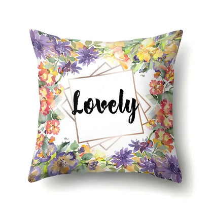 Square pillow cover with vibrant floral design and lovely script in gold frame featuring decorbites green tropical leaves