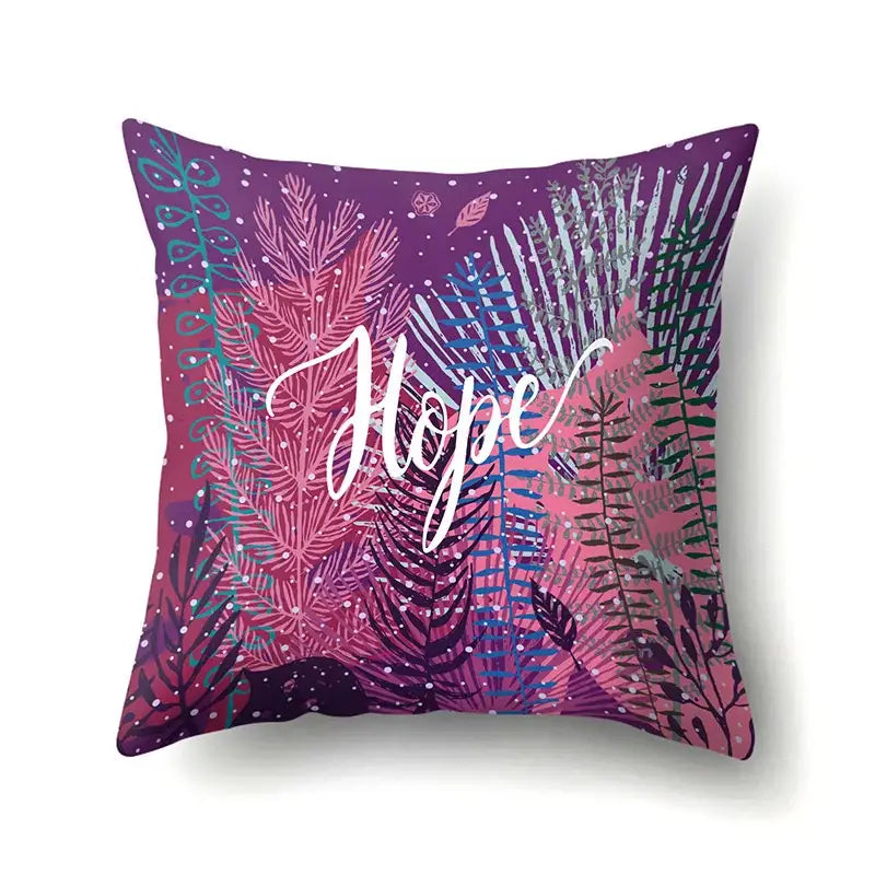 Purple and pink pillow cover with vibrant green tropical leaves and hope in white cursive for decorbites bedroom decor