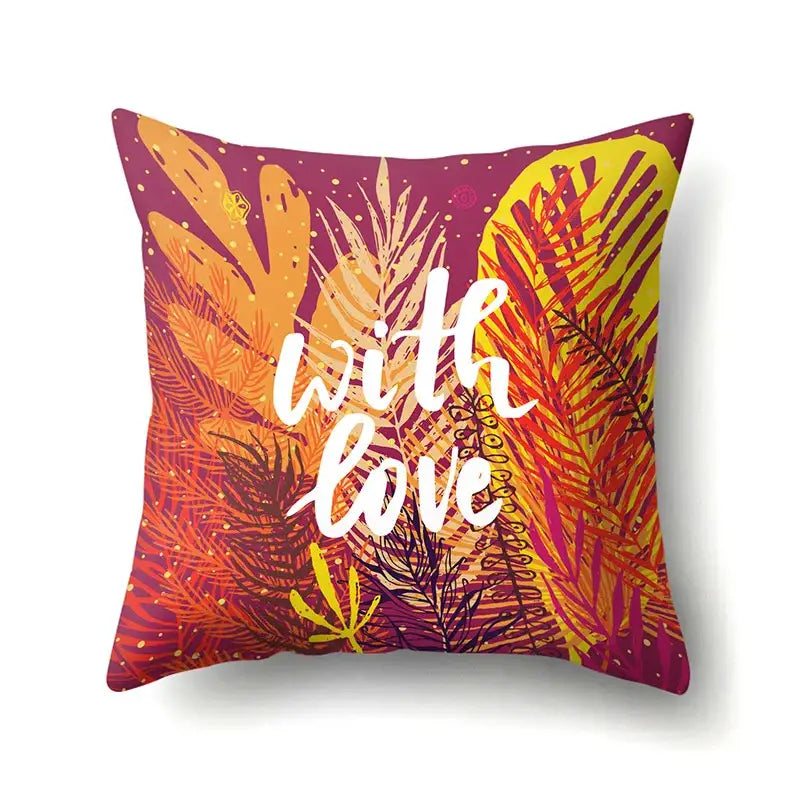 Vibrant pillow cover featuring green tropical leaves and orange magenta hues with with love script for decorbites green tropical decor