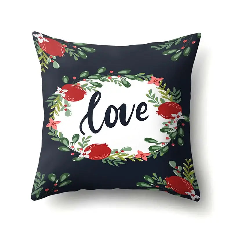 Navy blue pillow cover with white oval center featuring love text and green tropical leaves with red pomegranates decorbites green tropical