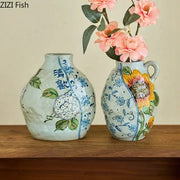 Two hand-painted decorbites ceramic vases with artificial flowers featuring floral and sunflower designs for living room decor