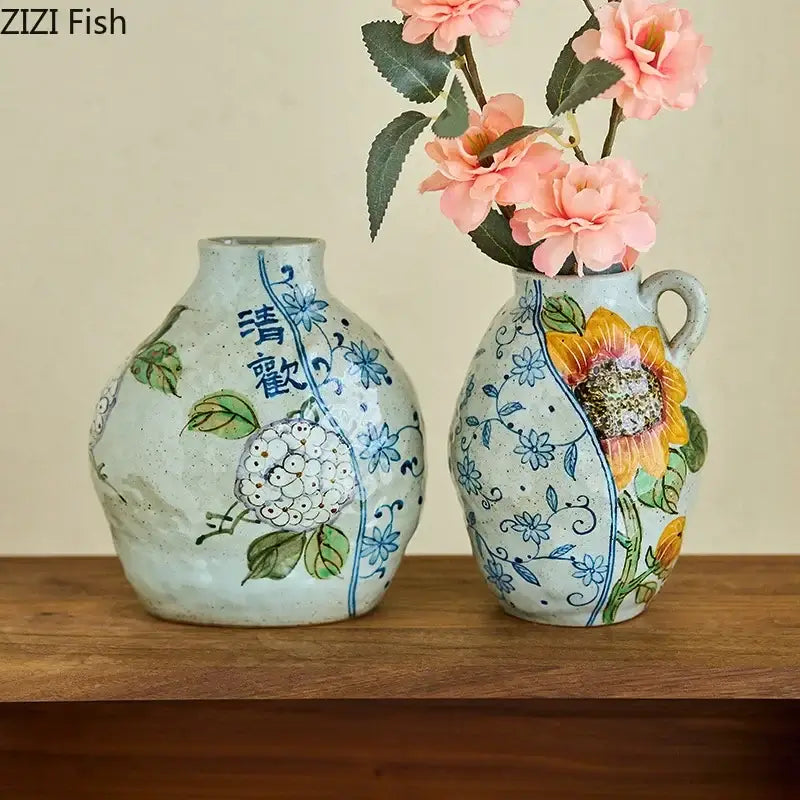 Two hand-painted decorbites ceramic vases with artificial flowers featuring floral and sunflower designs for living room decor