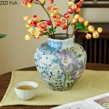 Floral hand painted decorbites ceramic vase with textured off-white glaze and blue purple patterns with artificial flowers