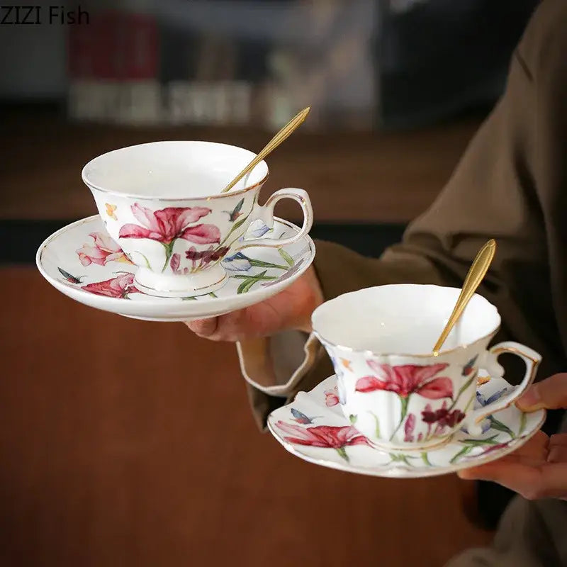 White porcelain mug set with decorbites iris pattern featuring pink lilies and gold spoons for elegant dining room use